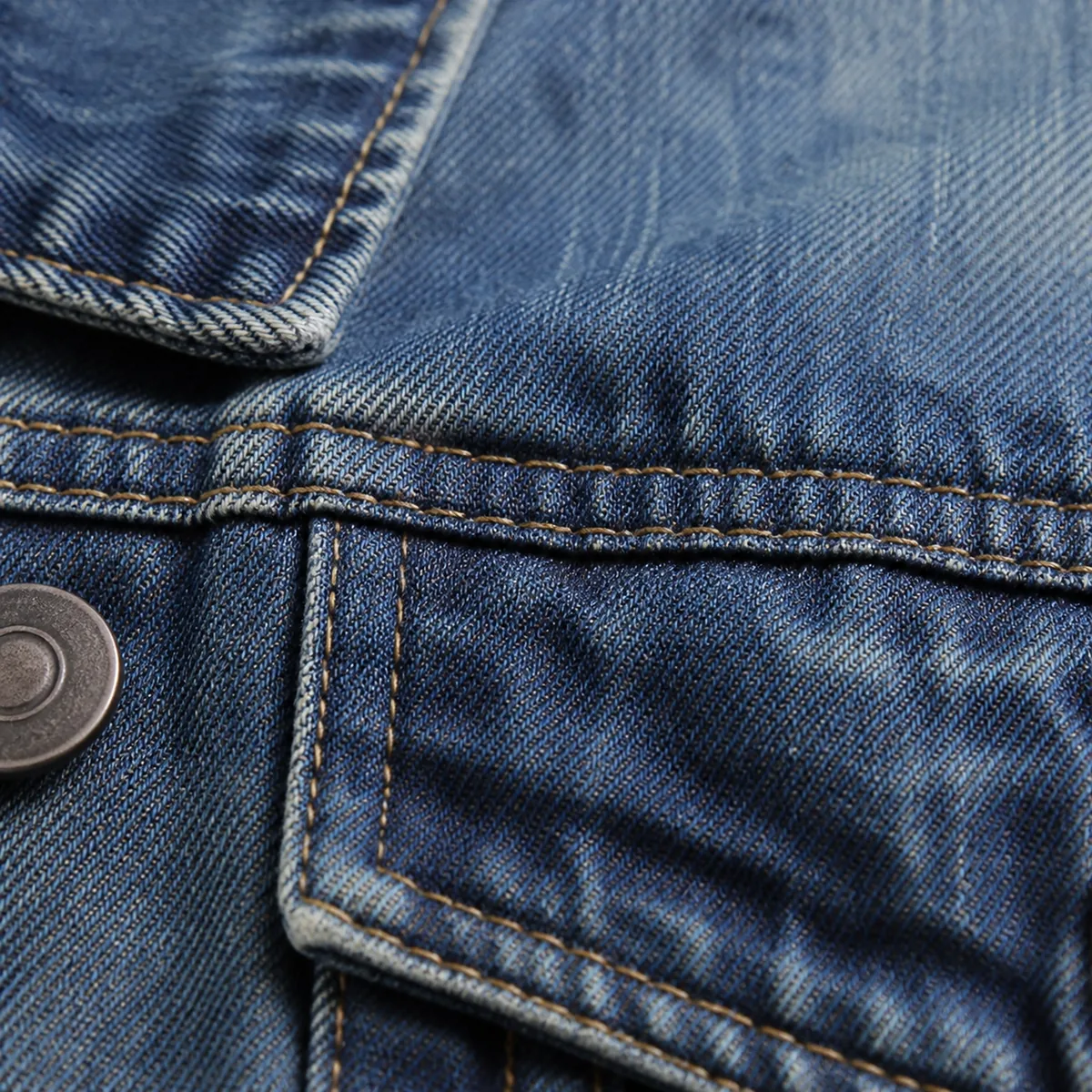 Denim shirt-jacket fabric, seam and button close-up