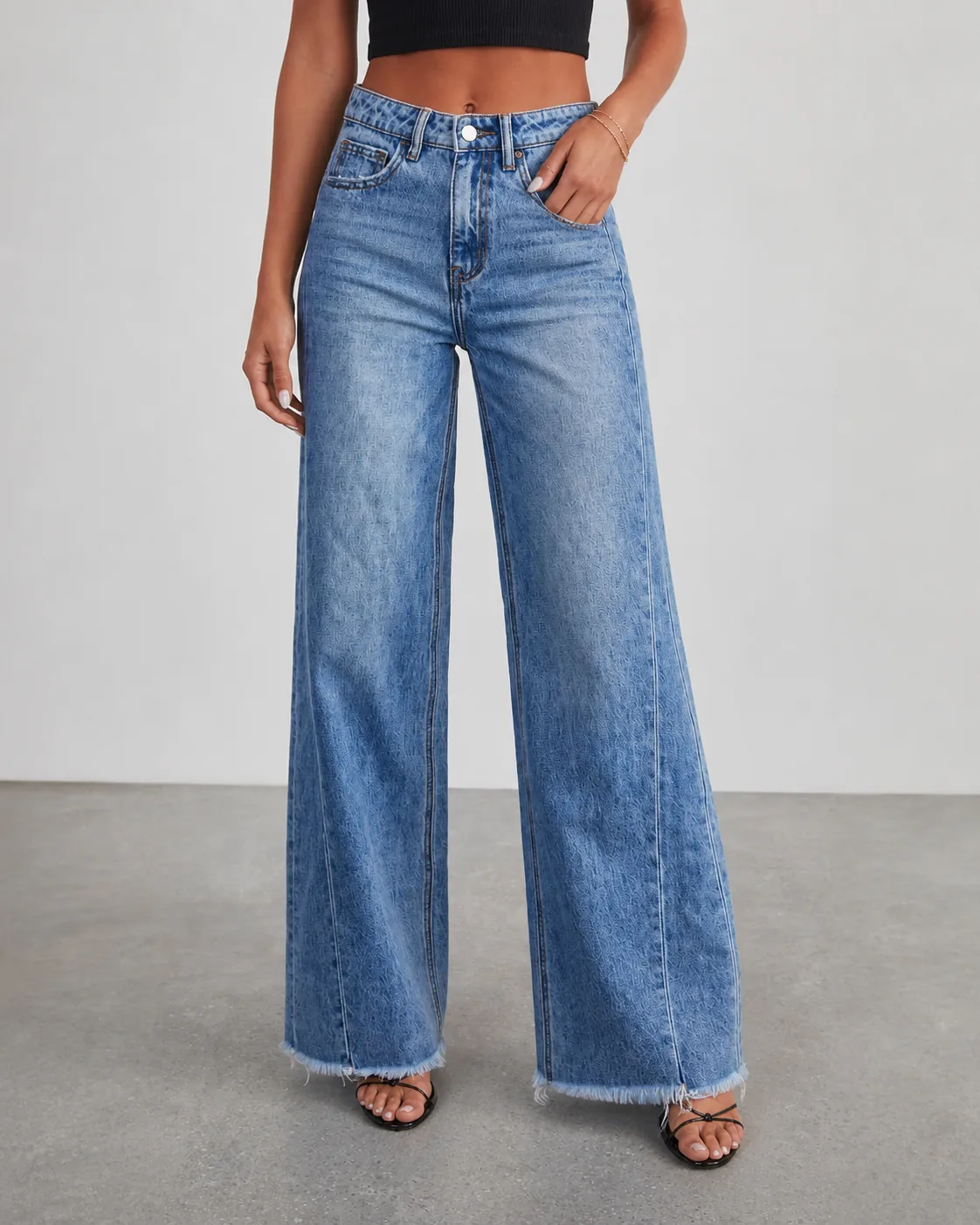 On-body view of women's jeans showing rise and wide-leg silhouette